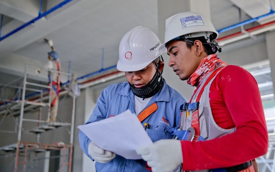 Construction workers reviewing site plans